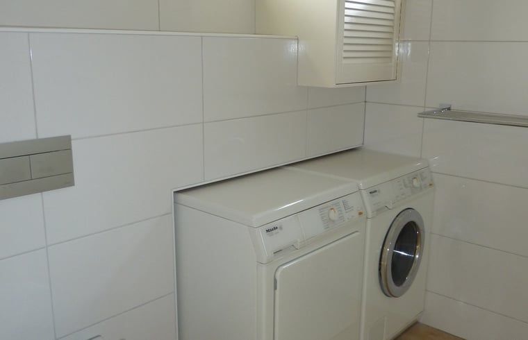 Laundry room with washer and dryer in Holiday home in Dishoek, Walcheren.