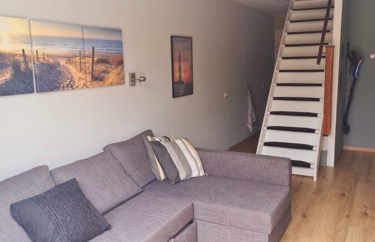 Cozy living room in Holiday home in Breskens, Zeeuws-Vlaanderen, Zeeland. Relaxed atmosphere with comfortable sofa.