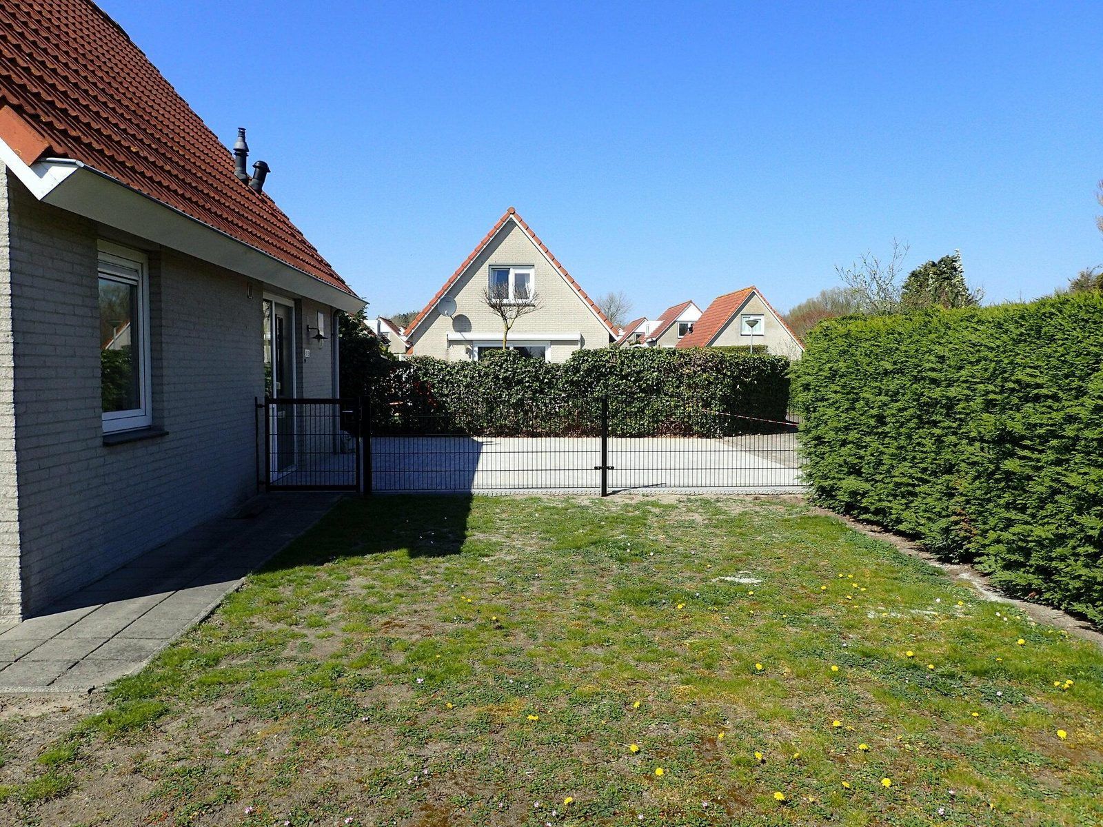 Spacious garden at VZ921 Holiday home in Cadzand-Bad, ideal for relaxation in Zeeland.