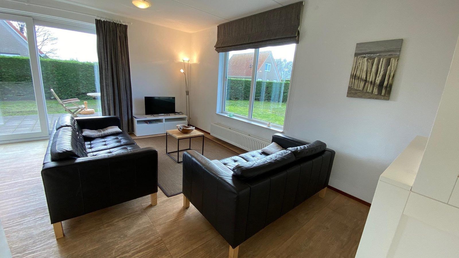 Cozy living room of VZ921 Holiday home in Cadzand-Bad overlooking the garden, Zeeland.