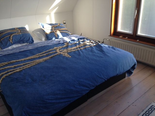 Comfortabele slaapkamer met tweepersoonsbed in vakantiehuis Landstraat, Aardenburg, Zeeland.