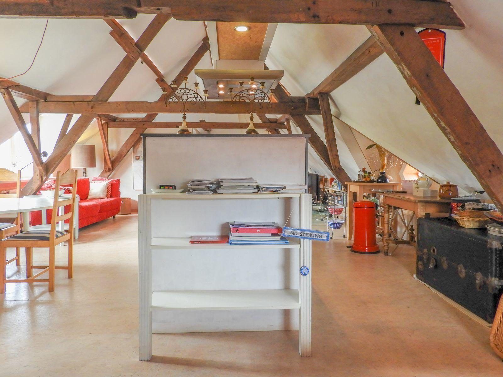 Open living space in VZ052 Apartment Sluis, Sluis, Zeeuws-Vlaanderen with rustic wooden details.