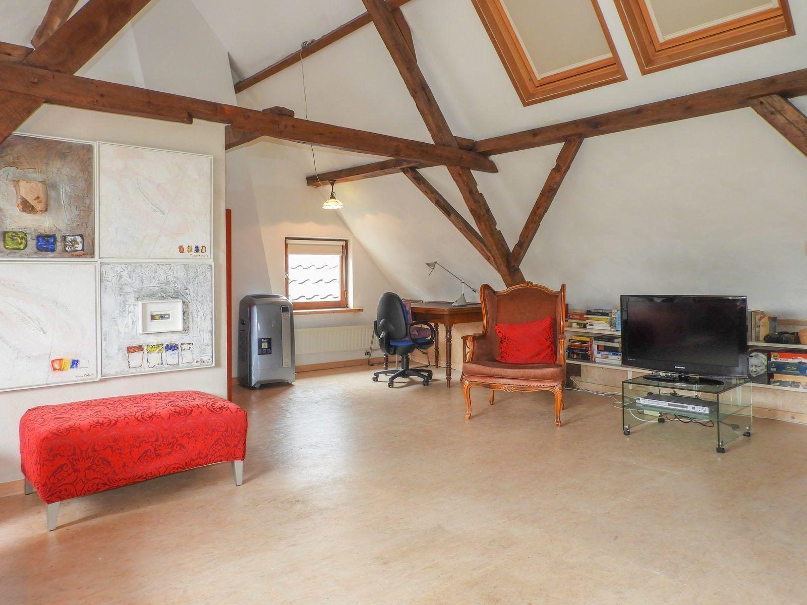 Spacious living room in VZ052 Apartment Sluis in Sluis, Zeeuws-Vlaanderen with workspace.