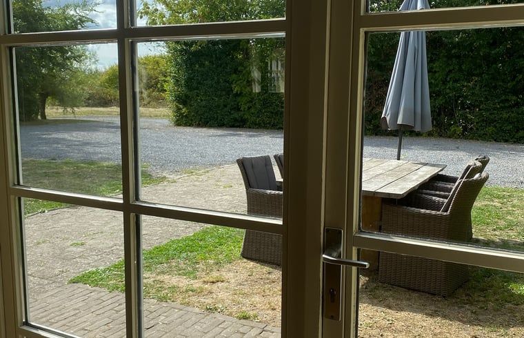 View from Holiday Home in Biervliet, Zeeuws-Vlaanderen, with terrace and garden furniture, ideal for relaxing in the nature of Zeeland.