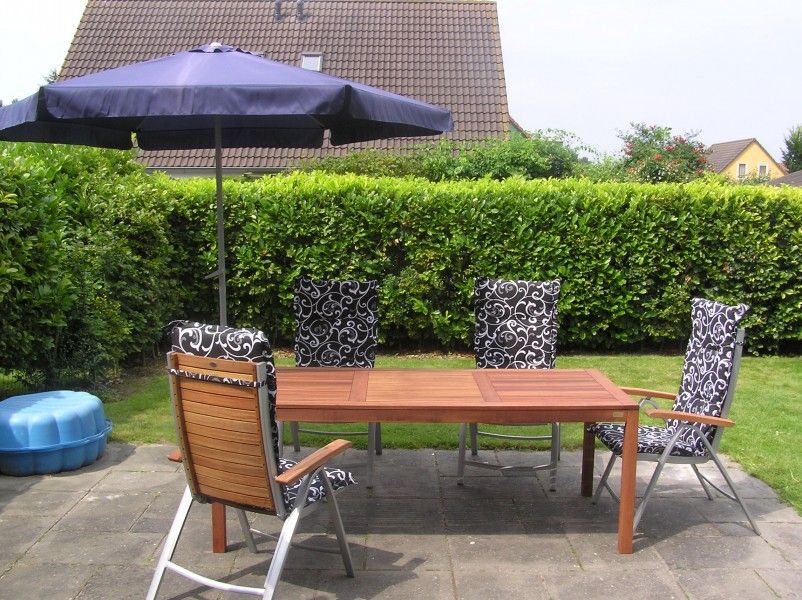Spacious terrace at Vermare in Wemeldinge, South Beveland, with comfortable garden chairs and parasol.