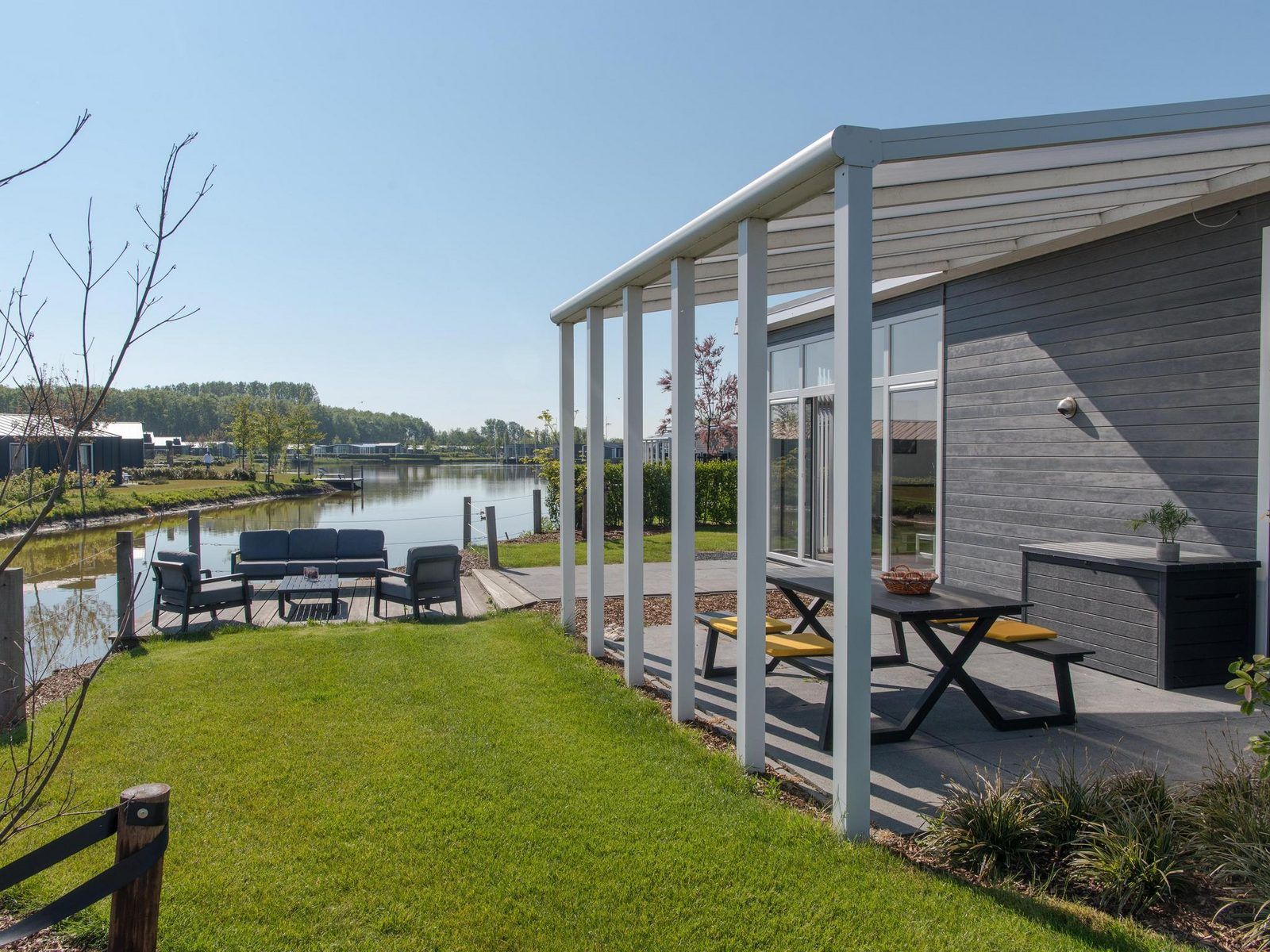Terrace overlooking the water at Holiday home Waterresort Oosterschelde - house no. 38 in Wemeldinge, Zeeland.