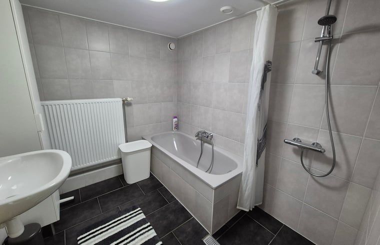 Stylish bathroom with bathtub and shower in Cottage in Lewedorp, perfect for relaxation in Zeeland.