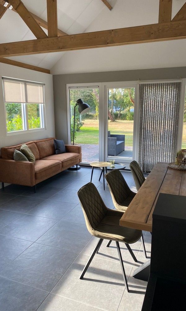 Bright living room with wooden beams in vacation home Vrijheid, Ouddorp, Goeree-Overflakkee, South Holland.