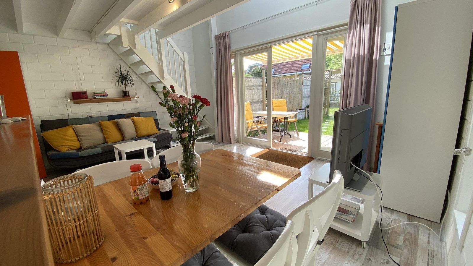 Lichte woonkamer van VZ990 Vakantiewoning in Ouddorp met uitzicht op de tuin in Zuid-Holland.