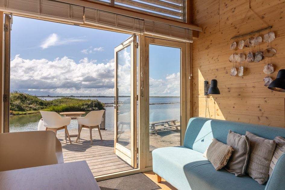 Geniet van het prachtige uitzicht vanaf de veranda van ECO Cottage in Ouddorp, een idyllisch vakantiehuis aan het water in Zuid-Holland.