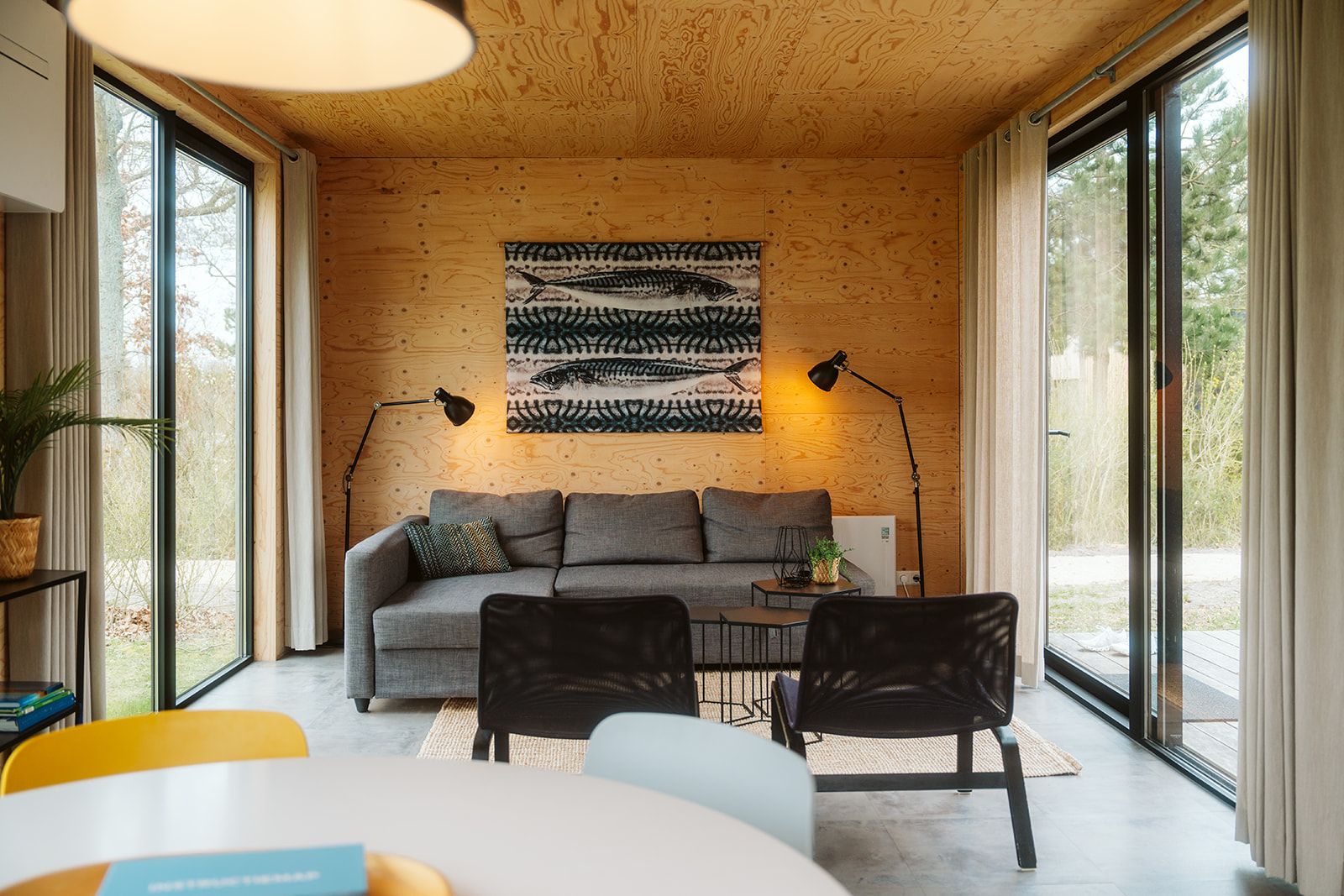 Cozy living room of Duunroos vacation home in Ouddorp, with wooden interior and lots of light.