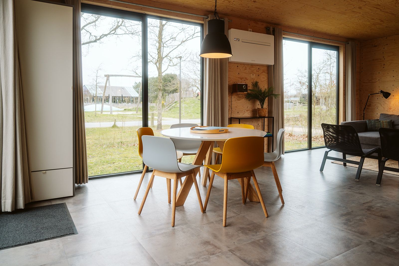 Modern dining area in Duunroos vacation home, Ouddorp, with lots of light.