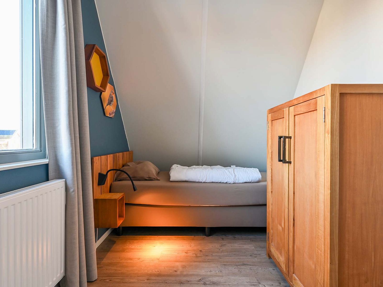 Gezellige slaapkamer met houten kast in vakantiehuis Reeuwijk, Zuid-Holland.