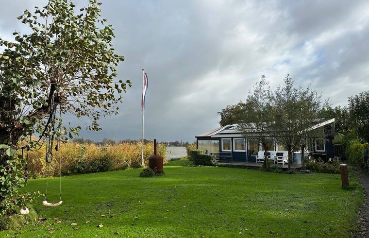 Cozy living room of Holiday home in Reeuwijk overlooking the water, ideally located in the Green Heart of South Holland.