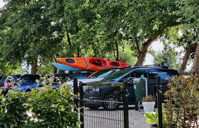 Kayaks and cars at cottage in Nieuwveen, South Holland.