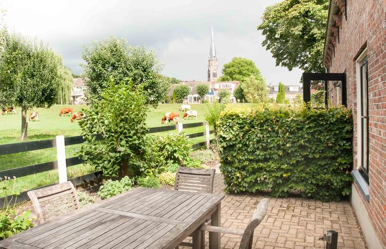 Terrace overlooking green fields at Holiday home in Nieuwveen, Green Heart, South Holland.