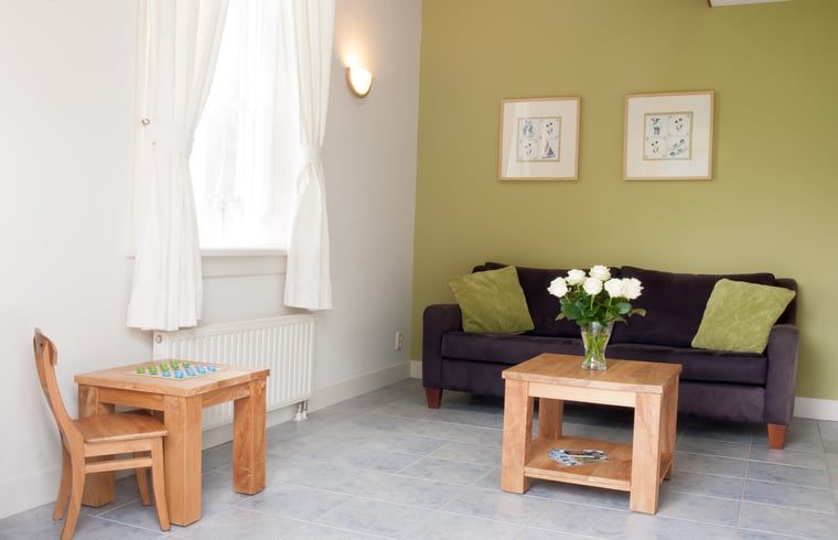 Cozy living room with flowers in Holiday home in Nieuwveen, Green Heart, South Holland.