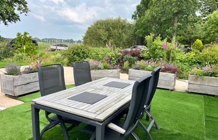 Enjoy the terrace at Holiday Home in Noorden, Green Heart, South Holland, surrounded by lush nature and rustic charm.