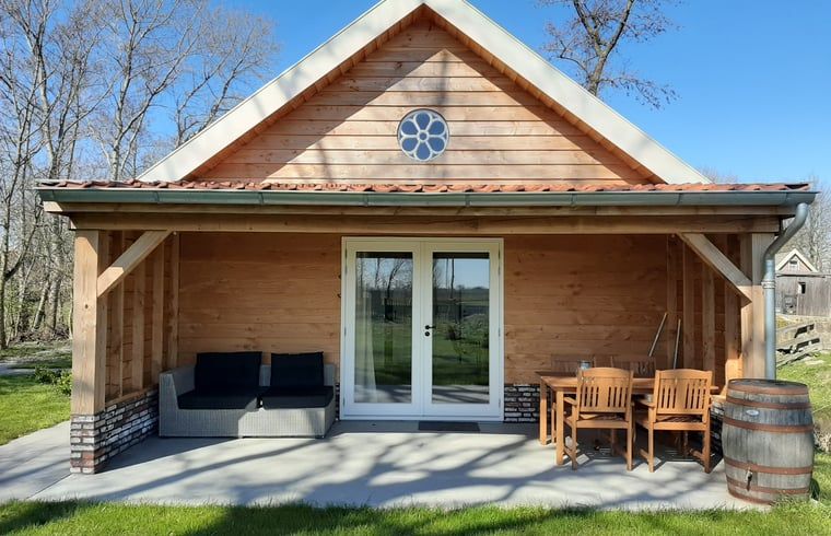 Vacation home in Hazerswoude-Rijndijk with wooden veranda and garden view, located in the Green Heart of South Holland.