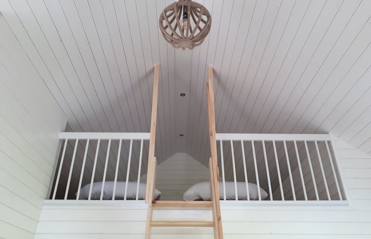 Cozy sleeping loft in Holiday home in Hazerswoude-Rijndijk, Green Heart, South Holland, with wooden interior and comfortable beds.
