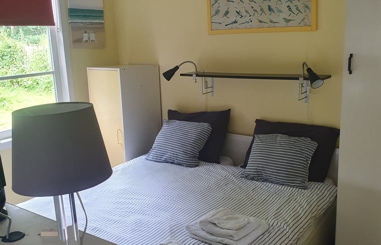 Spacious bedroom in Holiday home in Oostvoorne, perfect for a good night's sleep.
