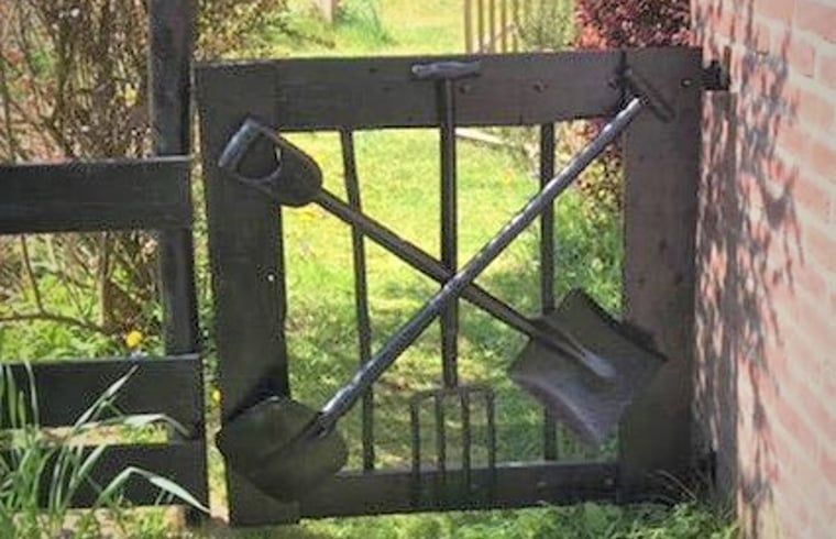 Unique garden gate at Holiday home in Oostvoorne, South Holland, with rural charm.
