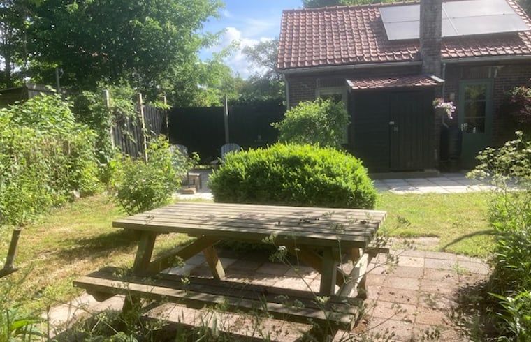 Picnic table in the garden of Holiday home in Oostvoorne, perfect for outdoor meals.