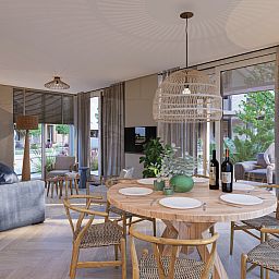 Stylish dining area in Chalet in De Cocksdorp, Texel, with wooden table and atmospheric decor on the Wadden Islands.