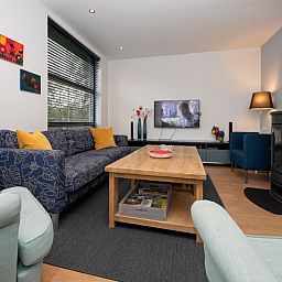 Cozy living room in Holiday home Slufteroord 240, Texel with comfortable seating area and modern furnishings.