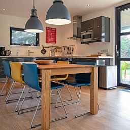 Stylish kitchen in Holiday home Slufteroord 240, Texel with modern appliances and dining area for six.