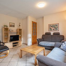 Cozy living room of Holiday home Slufterduin 094 in De Cocksdorp, Texel. Comfortable seating area and modern furnishings for a relaxing stay.