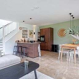 Modern kitchen and dining area in Holiday home De Razende Bol, De Cocksdorp, Texel, with stylish furnishings.