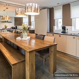 Large dining room in Family Villa 16 persons, De Cocksdorp, Texel with long wooden table.