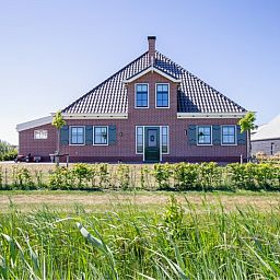 Voorzijde van Appartement B, een vakantiewoning in De Cocksdorp, Texel, omringd door natuur.