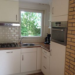 Moderne keuken in Vakantiehuis Slufteroord 270, Bungalowpark Slufteroord, De Cocksdorp, Texel met uitzicht op de natuur.