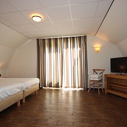 Lichte slaapkamer met balkon in Villa De Witte Hoek serre huisdiervrij, De Cocksdorp Texel, perfect voor ontspannen ochtenden.