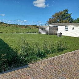 Enjoy the tranquility and green surroundings at Chalet Duunzicht, a vacation home in De Cocksdorp, Texel, overlooking the Wadden Islands.