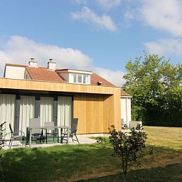 Enjoy the terrace of Holiday home D 449 in De Cocksdorp, Texel, surrounded by green nature on the Wadden Islands.