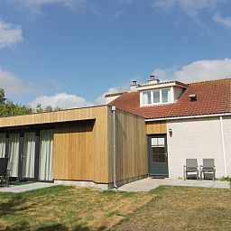 Vacation home D 449 in De Cocksdorp, Texel, offers a modern outdoor space with terrace and green surroundings on the Wadden Islands.