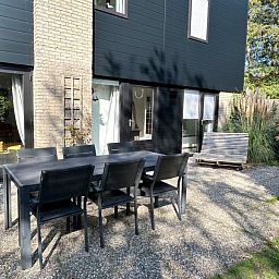 Geniet van het zonnige terras bij Vakantiehuis C 059 in De Cocksdorp, Texel, Waddeneilanden, omringd door groene natuur.