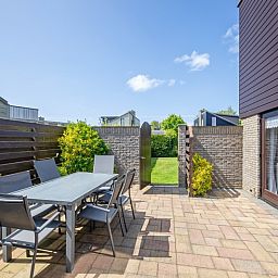 Enjoy the sunny patio of Holiday home A 309 in De Cocksdorp, Texel. Ideal for relaxation on the Wadden Islands.