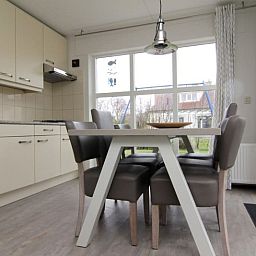 Cozy dining area in Holiday home D 730, De Cocksdorp, Texel. Bright interior with spacious kitchen and views of the Wadden Islands garden.