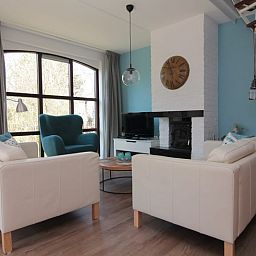 Gezellige woonkamer van Vakantiehuis D 437 in De Cocksdorp, Texel, met comfortabele zitruimte en sfeervolle open haard.