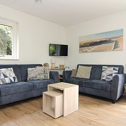Gezellige woonkamer in Vakantiehuis A 287, De Cocksdorp, Texel, met comfortabele banken en moderne inrichting voor een ontspannen verblijf.