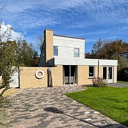 Vacation home B 011 in De Cocksdorp, Texel, offers a serene vacation experience with modern architecture and green surroundings.