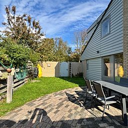 Enjoy the sunny garden at Holiday home B 011 in De Cocksdorp, Texel. Perfect for terrace relaxation in the Wadden Islands.