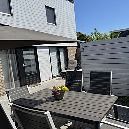 Enjoy the sunny terrace of Holiday Home A 301 in De Cocksdorp, Texel, with comfortable seating and a peaceful atmosphere.