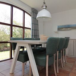 Cozy dining room in Holiday home E 645, De Cocksdorp, Texel with large windows and green view.