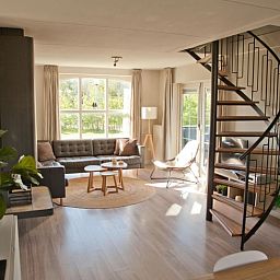 Gezellige woonkamer van Vakantiehuis F 808 in De Cocksdorp, Texel met licht interieur en uitzicht op de natuur van de Waddeneilanden.