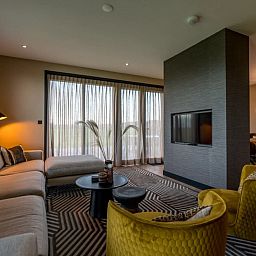 Gezellige woonkamer in 6 persoons vakantiewoning, De Cocksdorp, Texel met comfortabele zithoek en moderne decoratie.